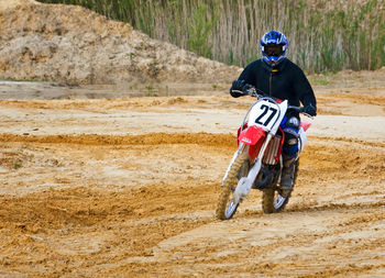 Man riding motorcycle on mud