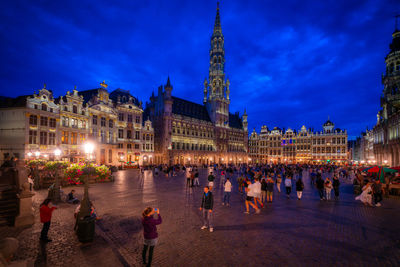 Group of people in illuminated building at night