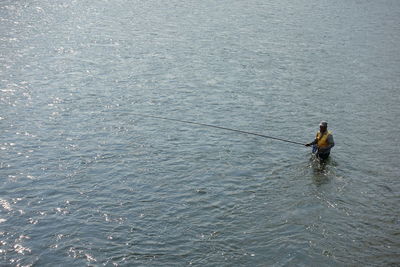 High angle view of man fishing in sea