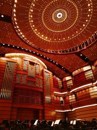 Low angle view of illuminated chandelier hanging in building