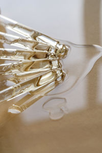 Pipettes with oil or serum on a golden background.