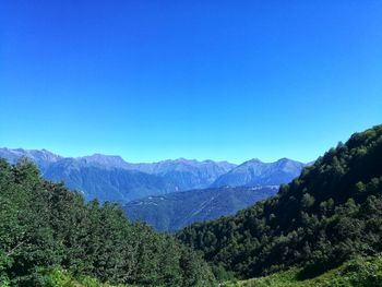 Scenic view of mountains against clear blue sky