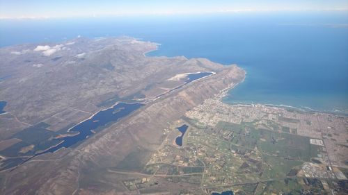 High angle view of land and sea against sky