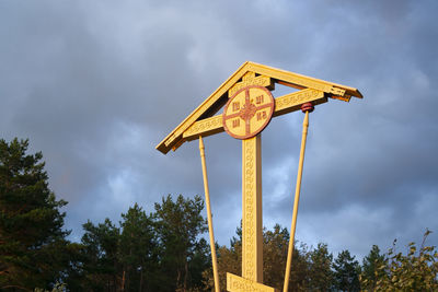 Low angle view of road sign against sky