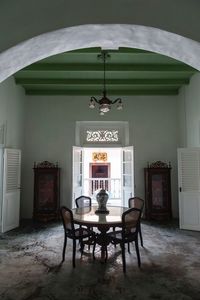 Empty chairs and table against building