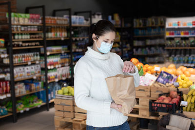 Full length of woman standing at store