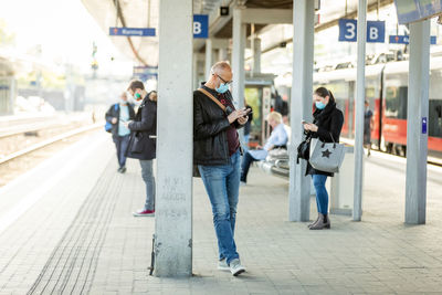 People standing on railroad station platform