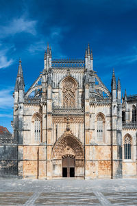 Facade of temple building against blue sky