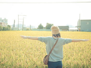 Woman standing on grassy field
