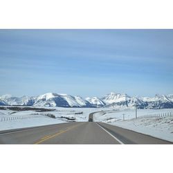 Scenic view of snow covered mountains against sky