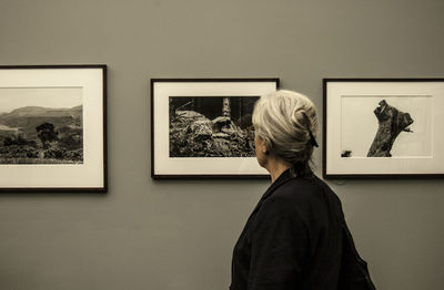 Rear view of man and woman standing in museum