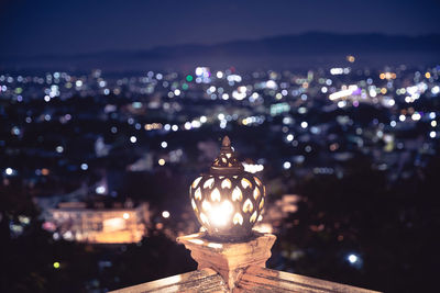 Close-up of illuminated buildings against sky at night