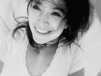 Close-up portrait of smiling young woman