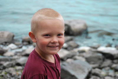 Portrait of boy smiling at sea shore