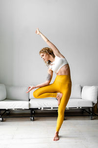 Beautiful woman performing yoga at home