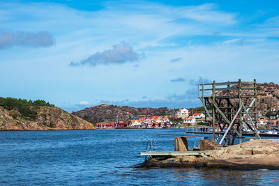 Scenic view of sea by buildings against sky