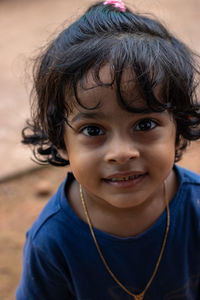 Close-up portrait of a beautiful little girl looking at camera with curious expression