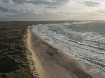 Scenic view of beach against sky during sunset