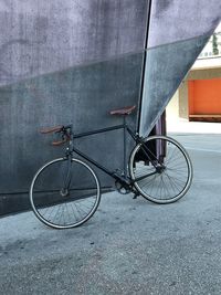 Bicycle leaning against wall