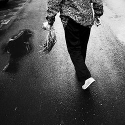 Low section of man walking on street