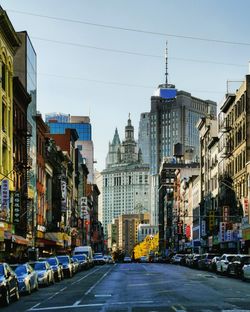 City street and buildings against sky