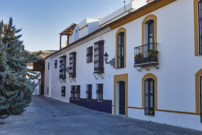 Street amidst buildings against sky in city