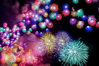 Low angle view of colorful firework display at night