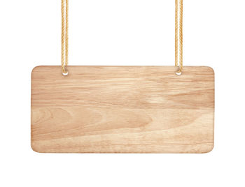 Close-up of empty swing against white background