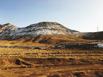 Scenic view of sand against clear sky