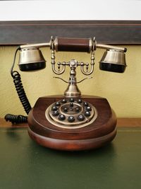 Close-up of old telephone on table