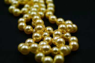 Close-up of pearl necklace on black background