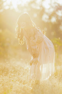 Midsection of woman standing on field