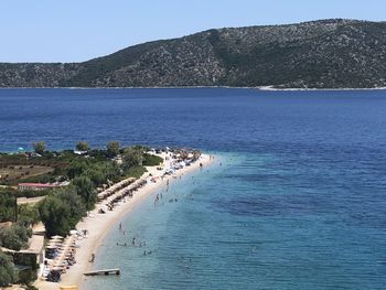 High angle view of sea against clear blue sky