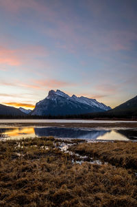 Calm lake against rocky mountains