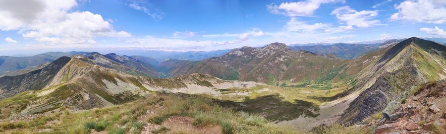 Panoramic view of mountains against cloudy sky