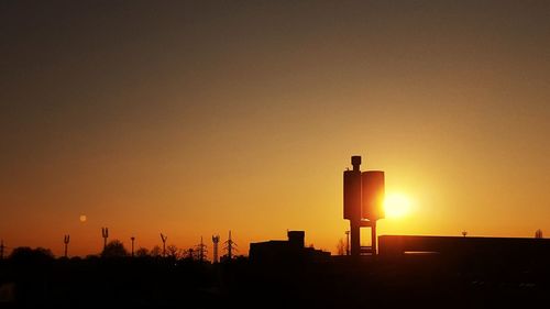 Low angle view of silhouette building against sky during sunset