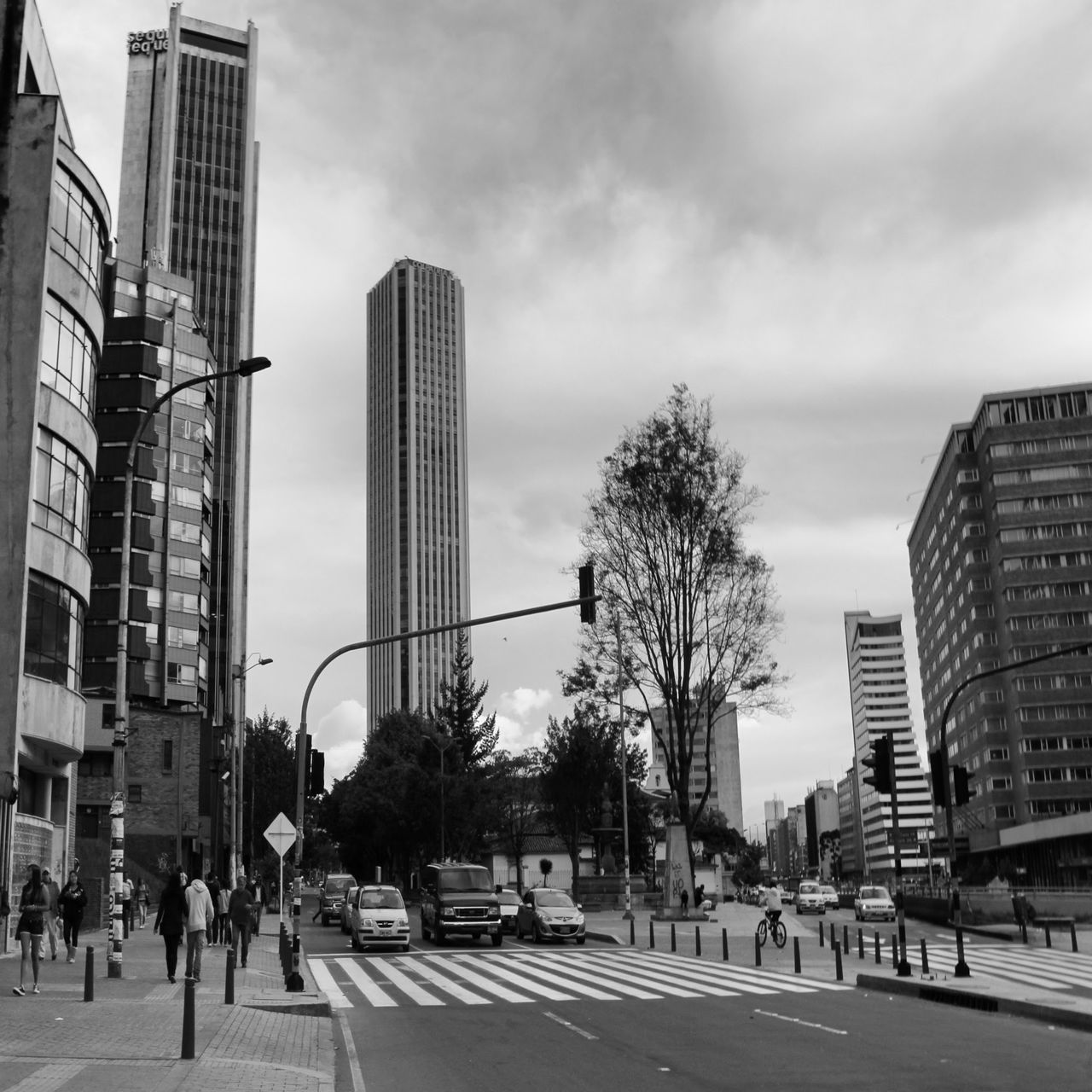 building exterior, architecture, built structure, city, sky, skyscraper, city life, street, office building, cloud - sky, modern, transportation, tall - high, building, road, tower, car, city street, men