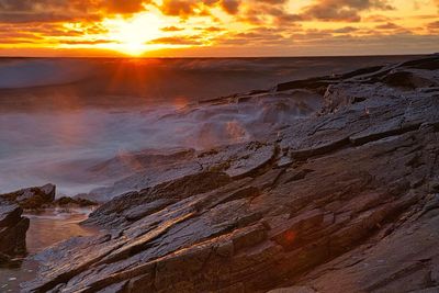 Rocks at sea during sunset