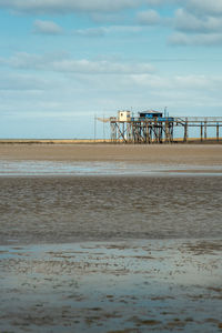 Typical old wooden fishing huts on stilts called carrelet near la rochelle, france. portrait format