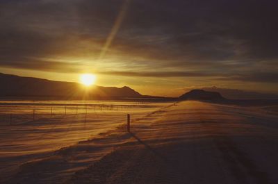 Scenic view of sunset over land