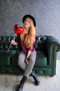 Portrait of beautiful young woman sitting at home