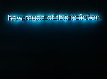 Close-up of illuminated text against black background