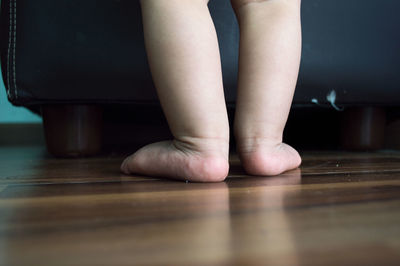 Low section of child on floor at home