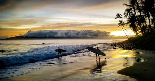 Scenic view of beach against sky during sunset