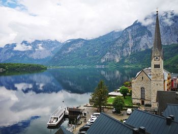 Panoramic view of lake and buildings against sky