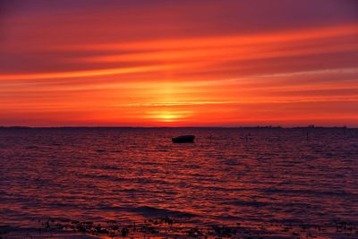 Scenic view of sea against orange sky