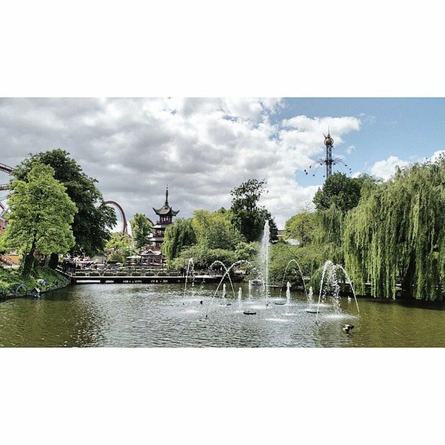 water, tree, sky, reflection, lake, transfer print, waterfront, cloud - sky, tranquility, tranquil scene, nature, scenics, auto post production filter, beauty in nature, river, cloud, growth, green color, fountain, day