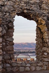 Scenic view of sea seen through arch