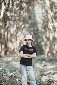 Portrait of teenage girl wearing hat standing on land