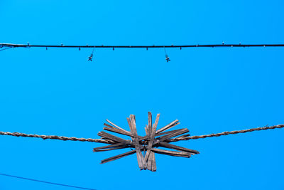 Low angle view of ferris wheel against clear blue sky